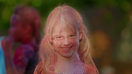 Girl Smiles Covered with Holi Colors
