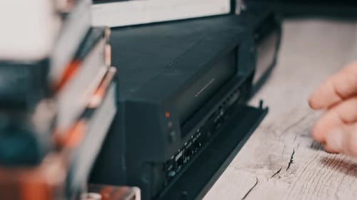Hand Loading VHS Tape in Vintage Player