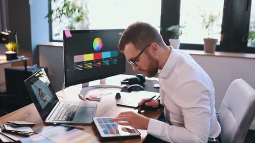 Man Works as Graphic Designer at Modern Desk