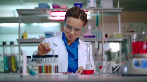 Focused Woman Scientist Working in Laboratory
