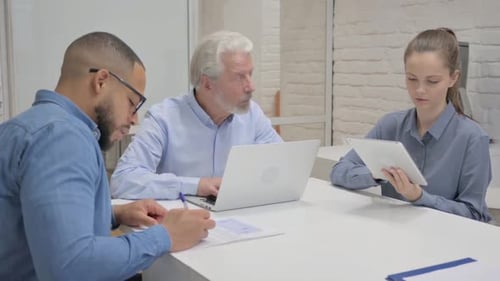 Group Working Together at a Table in Office