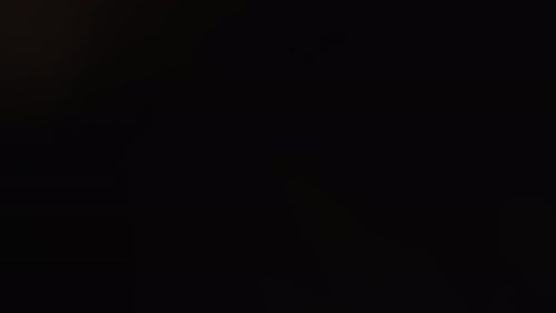 Shifting Light Flares on Dark Background