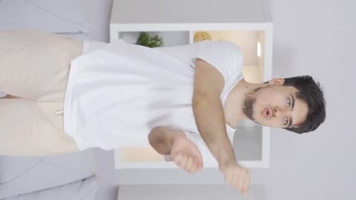 Young Adult Male Stretching Arm Indoors