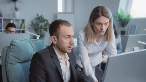 Teamwork in Modern Office: Man and Woman Collaborating