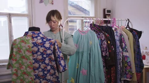 A Woman Designer Tries on Colorful Clothes on a Mannequin