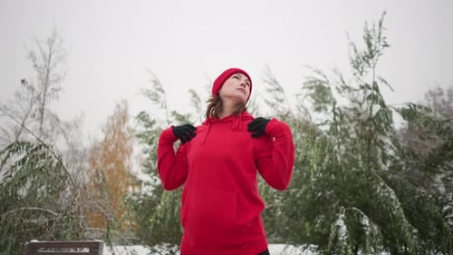 Adult Female Stretching in Snowy Winter Park