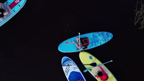Aerial View of People Paddleboarding on Calm Lake