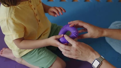 Thérapeute et enfant participant à une activité de motricité fine Séance d'ergothérapie pour les mains