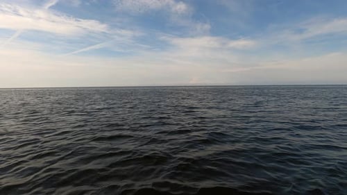 The camera which is installed on the motor boat moves at high speed capturing the sea and the sky