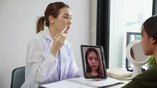 Doctor Consults Patient's Image on Tablet