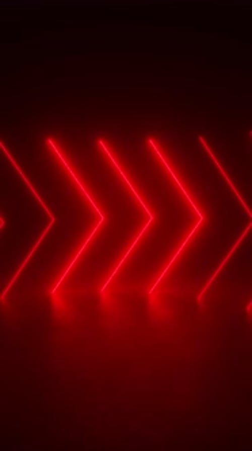 A tunnel of neon lights glows in a dark room