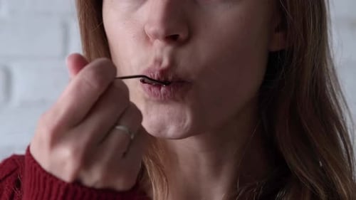 Woman Eating Cake Slice with Spoon Close Up