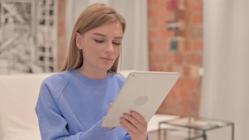 Woman Using Tablet Device Indoors