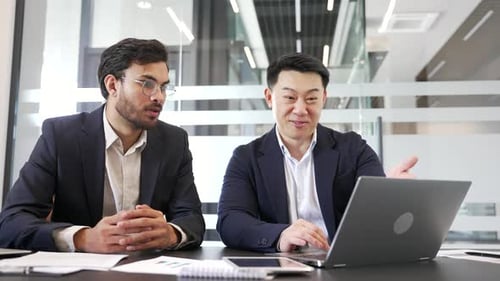 Excited Businessmen Celebrate Good News at Office