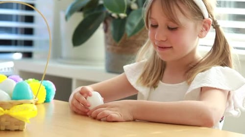 A Cute Little Girl Opens a Plastic Easter Egg with Colorful Jelly Beans Inside Egg Hunt Easter