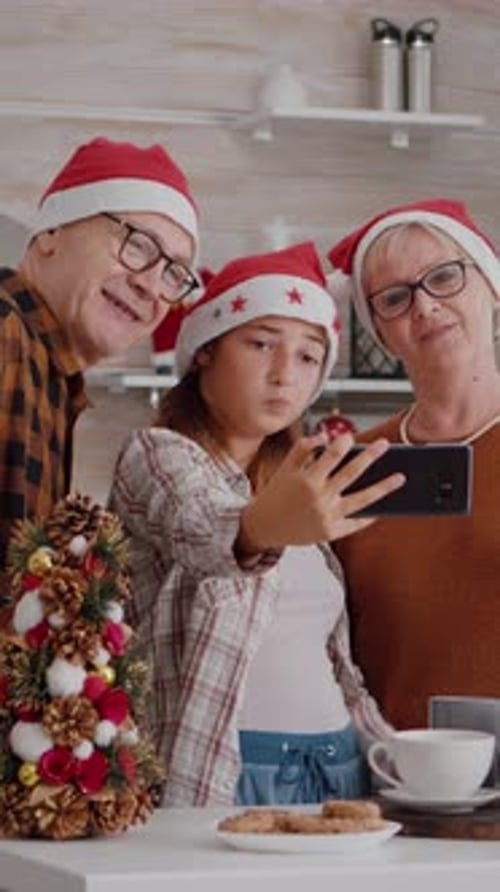 Family Christmas Selfie with Grandparents Wearing Santa Hats