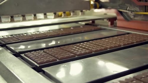 freshly made chocolate bars on the conveyor line