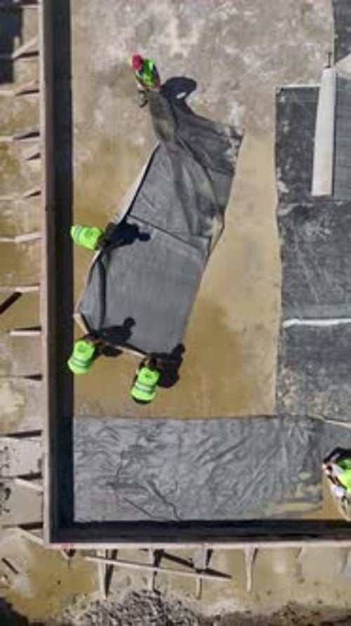 Vertical Video Construction Progress Captured From Above Featuring Metal Loading And Foundation