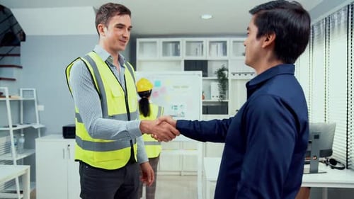Competent Businessman and Engineer Shake Hands to Each Other