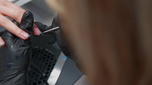 Woman Manicurist Serves a Client in a Spa Beauty Salon
