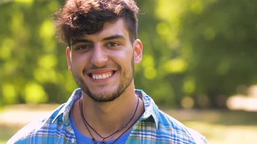 Smiling Young Man in Blue Shirt Outdoors