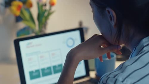 Young Adult Studies Charts on Laptop at Night