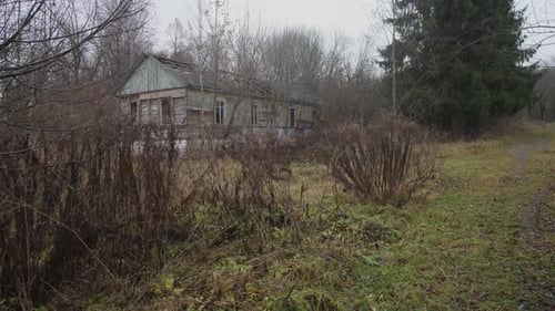 An Abandoned Industrial Building Now Overtaken By Nature Sits Quietly in the Countryside