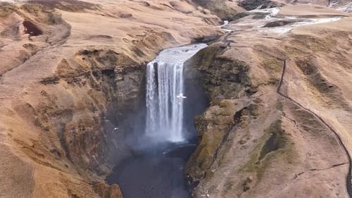 Aerial view of Skógafoss waterfall in Skógar, Iceland, as water plunges from high cliffs