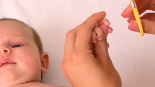 Infant Fingernails Being Clipped