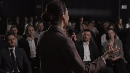 Woman Presenting Speech To Audience At Corporate Event