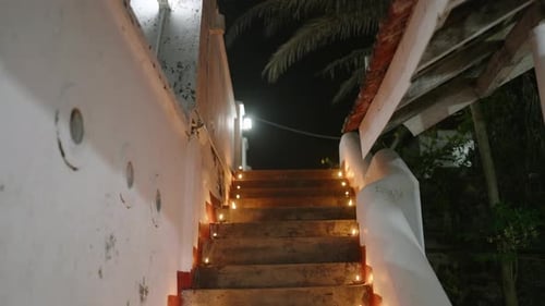 Stairs of Buddhist Temple Lit with Rows of Oil Lamps Celebrating Vesak Devotees Climb to Worship