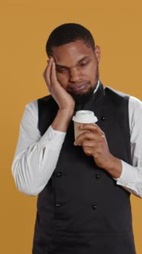 Vertical Video Tired Overworked Waiter Drinking a Coffee Cup to Relax After Long Shift