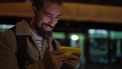 Handsome Young Man Using Smartphone Outdoors in the City