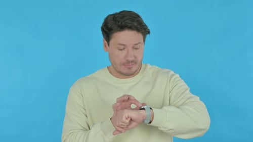Man Using Smart Watch on Blue Background