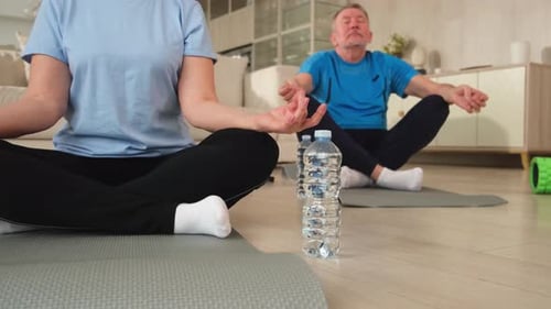 Mature Couple Meditating Peacefully at Home