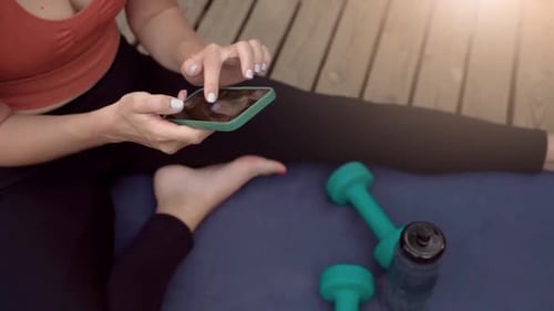 Woman Using Mobile Phone After Workout