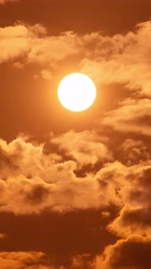Golden Sun Ascends Through an Orange Cloudscape