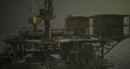 Oil Rig Platform Operates in the Ocean During Overcast Weather