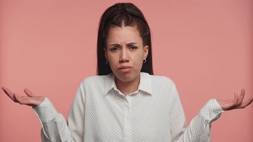Woman Shrugging Her Shoulders in Confusion