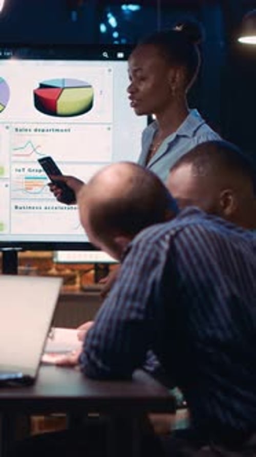 Business Presentation with Team in Modern Office at Night