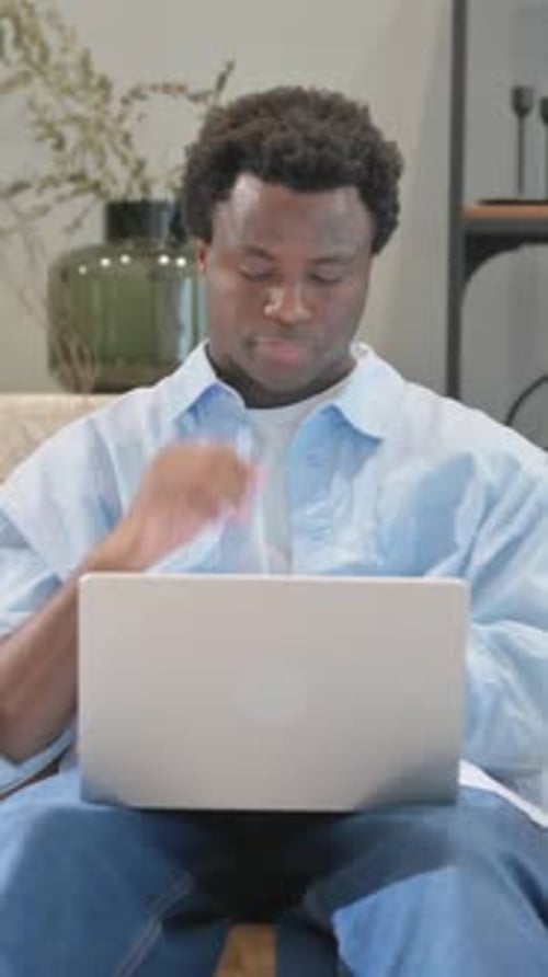 Man Thinks, Then Types on Laptop at Home