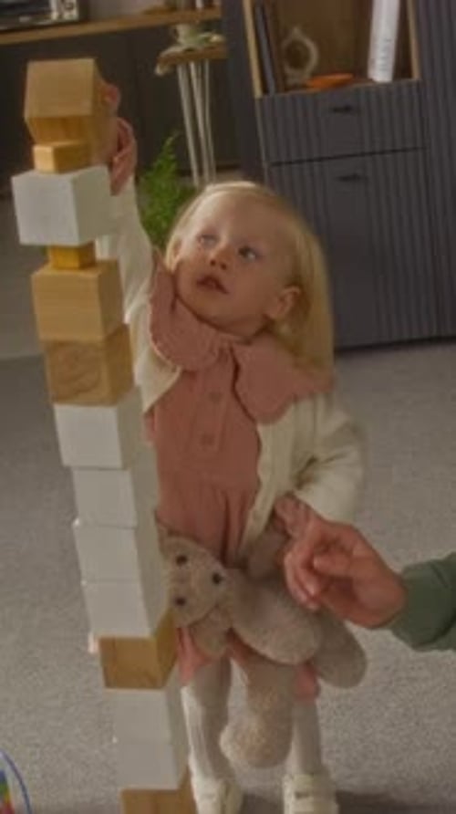 Brother and Little Sister Playing and Building Tall Tower Vertical