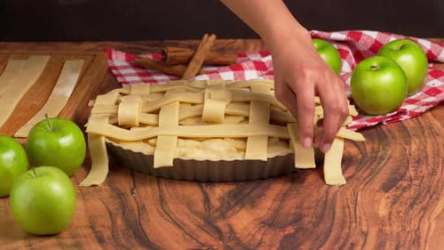 Preparing An Apple Pie, A Woman's Hands Place The Top Crust On A Homemade Pie