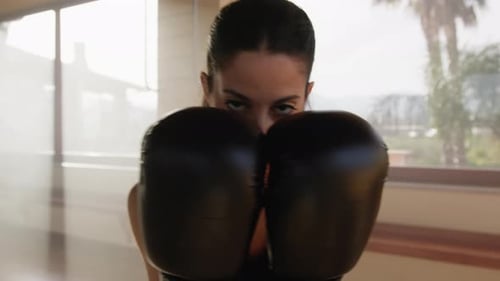 Woman Posing with Boxing Gloves Indoors