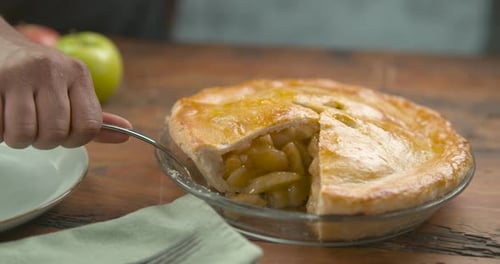 Big Slice Of Apple Pie Placed In A Pastel Blue Plate With A Palette Knife, On A Wood Table. Close...