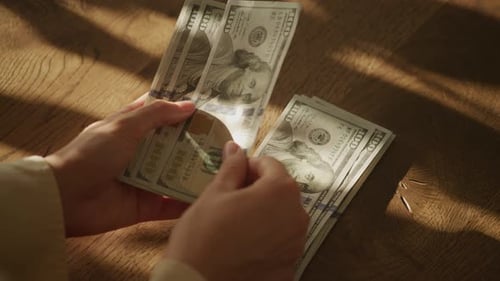 Handheld Close Up of Caucasian Woman Hands Counting Money in Slow Motion