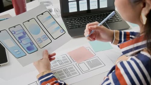Woman Designs Mobile Application Interface in Modern Office