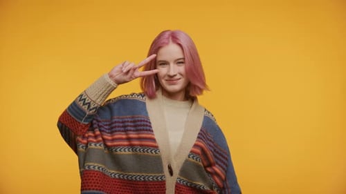 Smiling Young Adult Dances with Peace Sign
