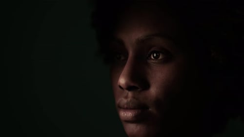 Dramatic Close-up Portrait of Woman in Shadow