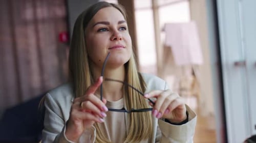 Businesswoman Takes off Her Glasses and Rubs Eyes